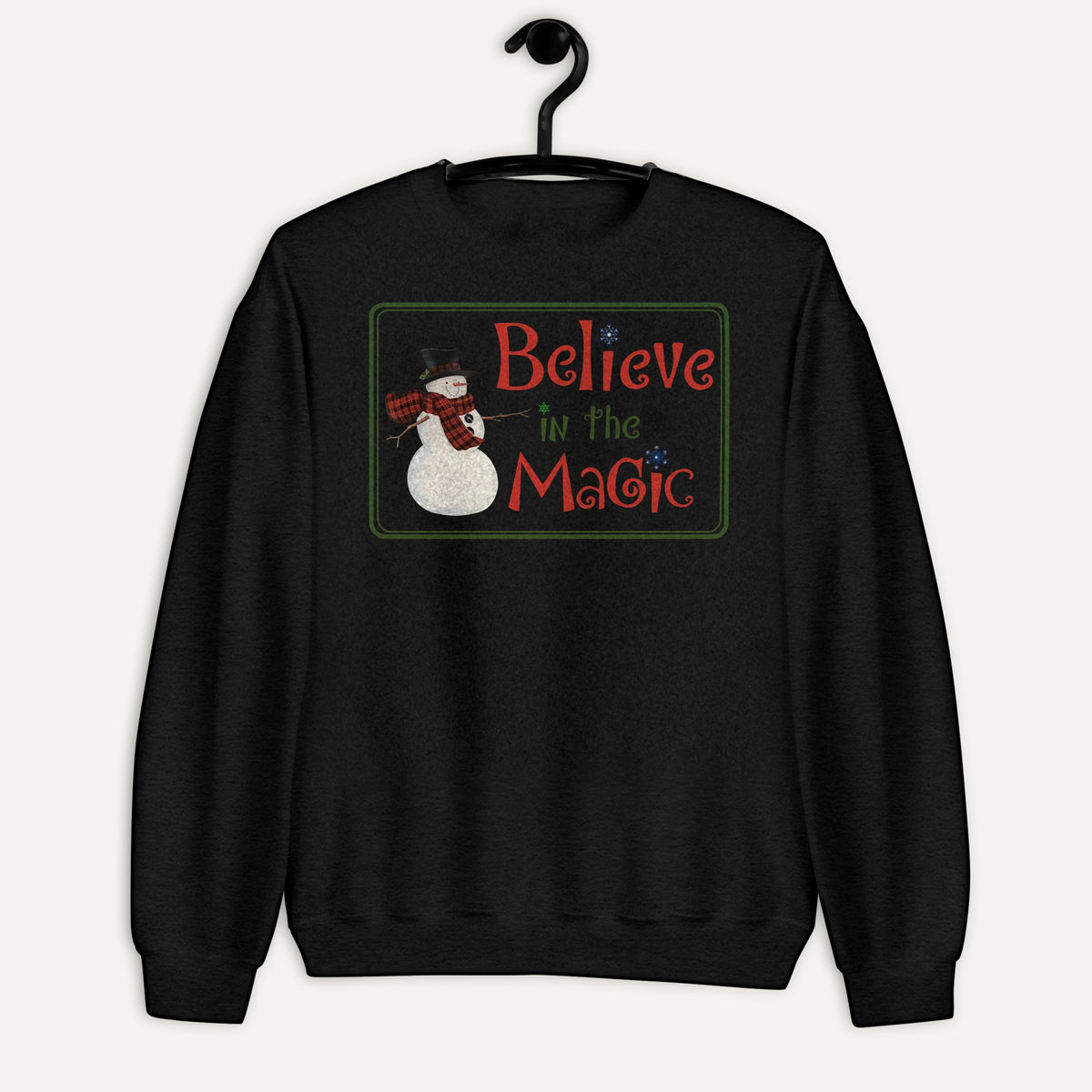 Believe In The Magic Unisex Long Sleeve Sweatshirt in Black, on hanger