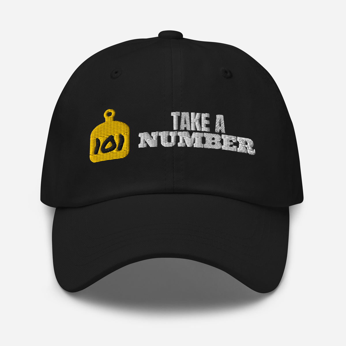 Take A Number Cow Tag Embroidered Dad Hat in Black, front view