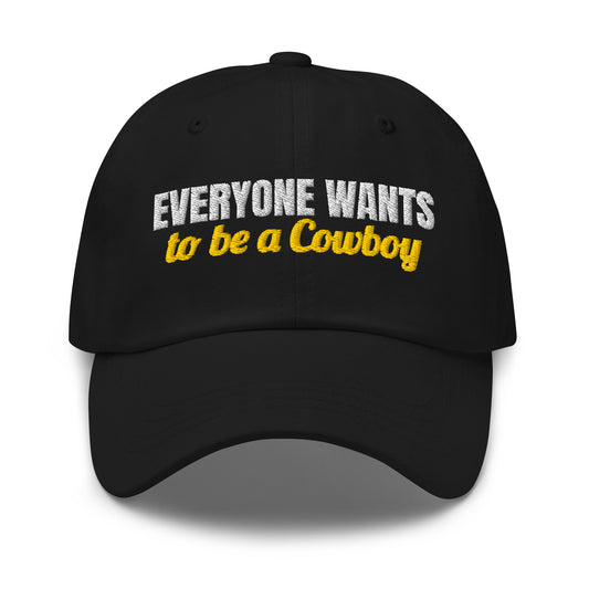 Everyone Wants To Be A Cowboy embroidered dad hat in Black with white and gold embroidery, front view