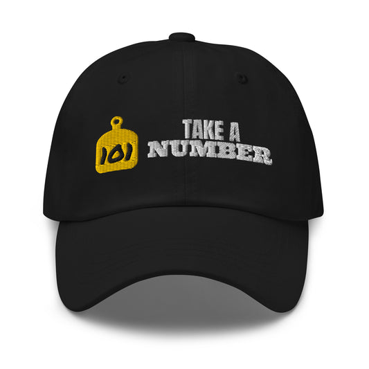 Take A Number Cow Tag embroidered dad hat in Black with gold, black and white embroidery, front view