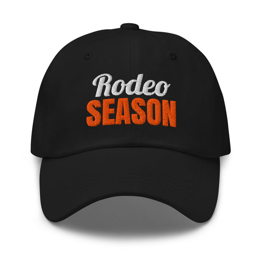 Rodeo Season embroidered dad hat in Black with orange and white embroidery, front view