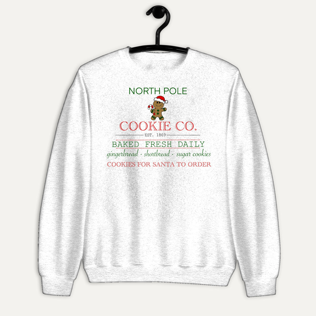North Pole Cookie Co. Unisex Long Sleeve Sweatshirt in White, on hanger