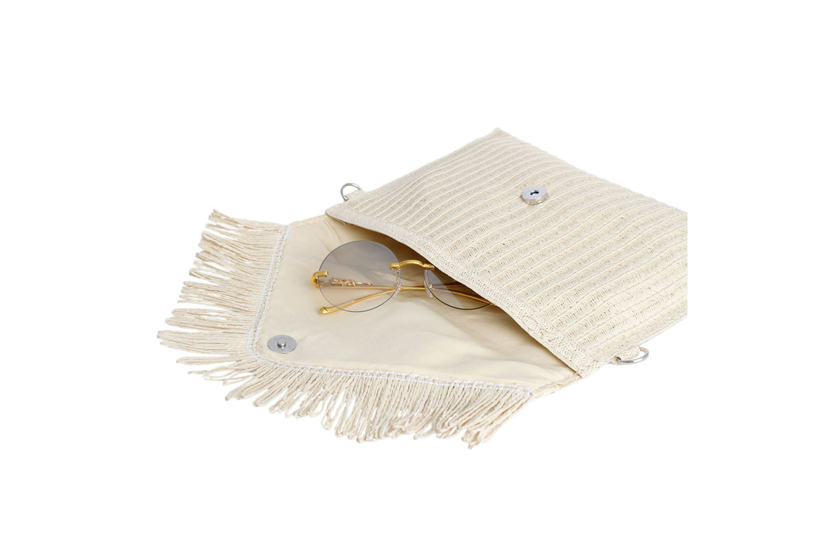 Cream straw fringe clutch with the flap open showing the inside