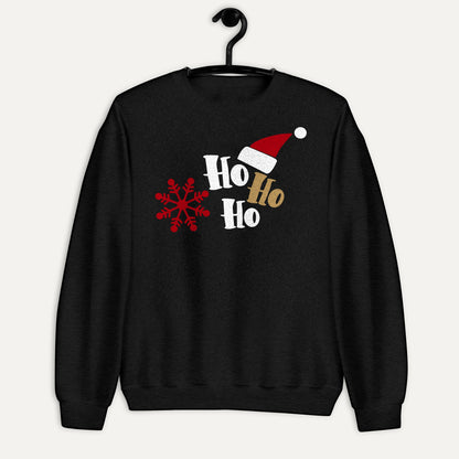 Ho Ho Ho Santa Hat And Snowflake Unisex Long Sleeve Sweatshirt in Black, on hanger