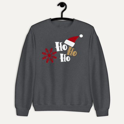 Ho Ho Ho Santa Hat And Snowflake Unisex Long Sleeve Sweatshirt in Dark Heather, on hanger