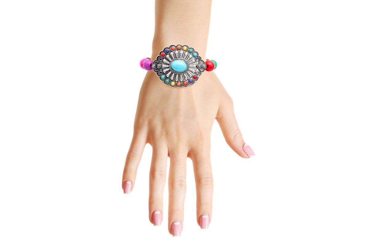 Model wearing a multicolor beaded stretch bracelet with a silver-tone concho