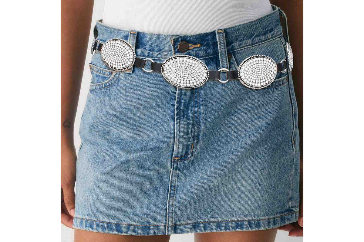 Rhinestone oval concho chain belt worn low on the hips with a denim skirt